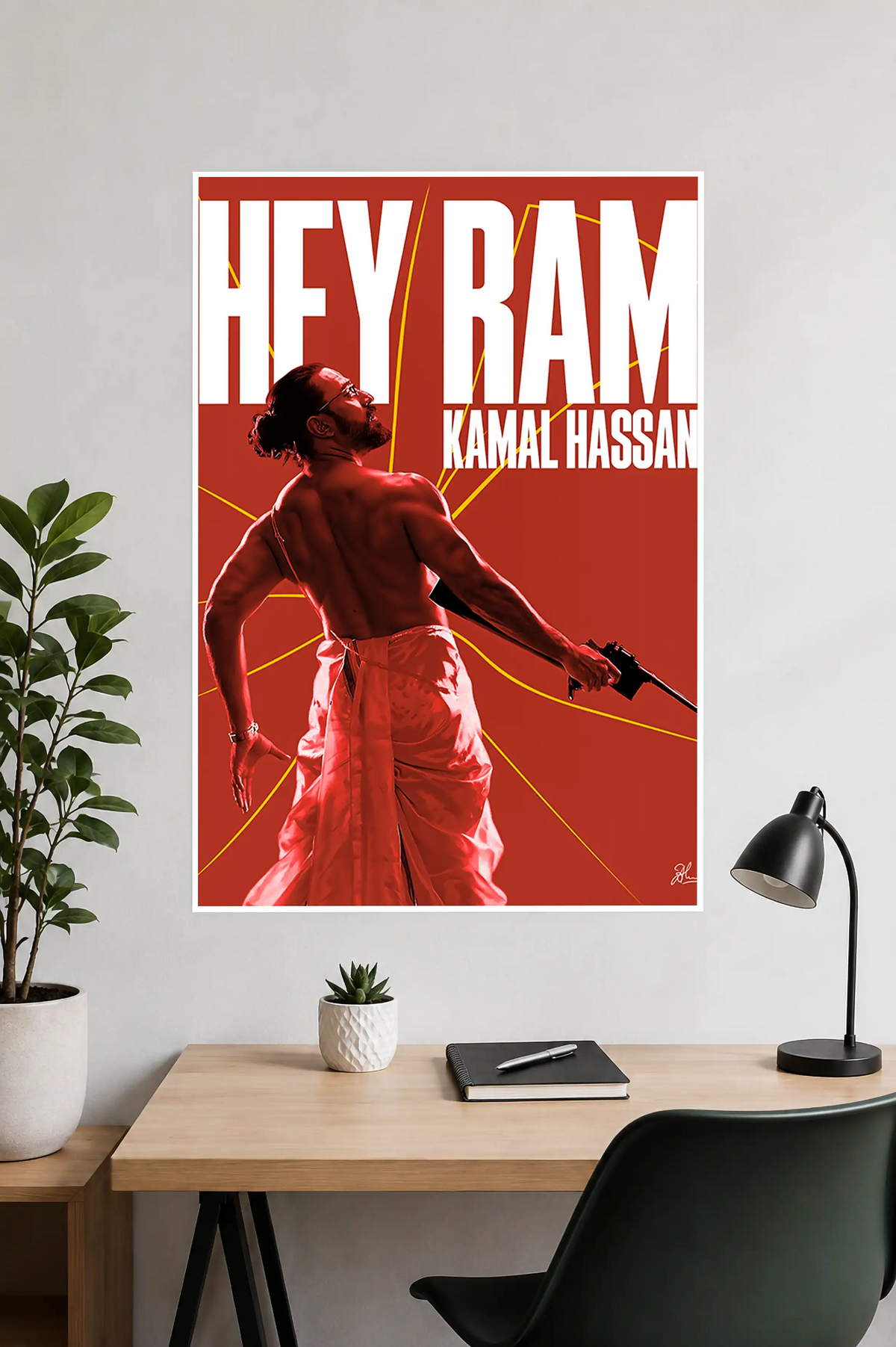 Image 2 (Desk Mockup View): Hey Ram Kamal Haasan wall poster hung above a modern wooden study desk and desk lamp.