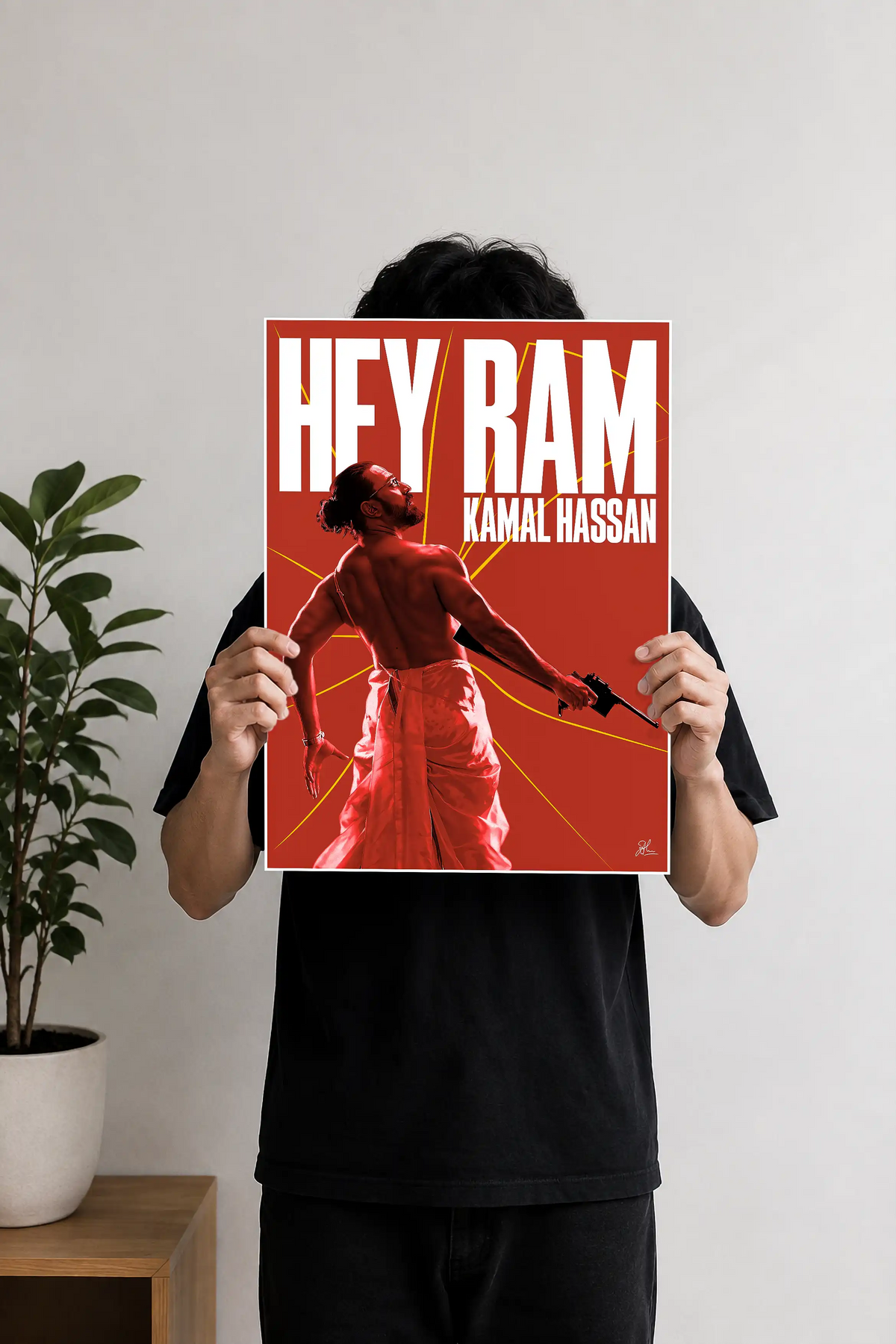 Image 1 (Handheld View): Person holding a red Hey Ram Kamal Haasan minimalist movie art poster print.