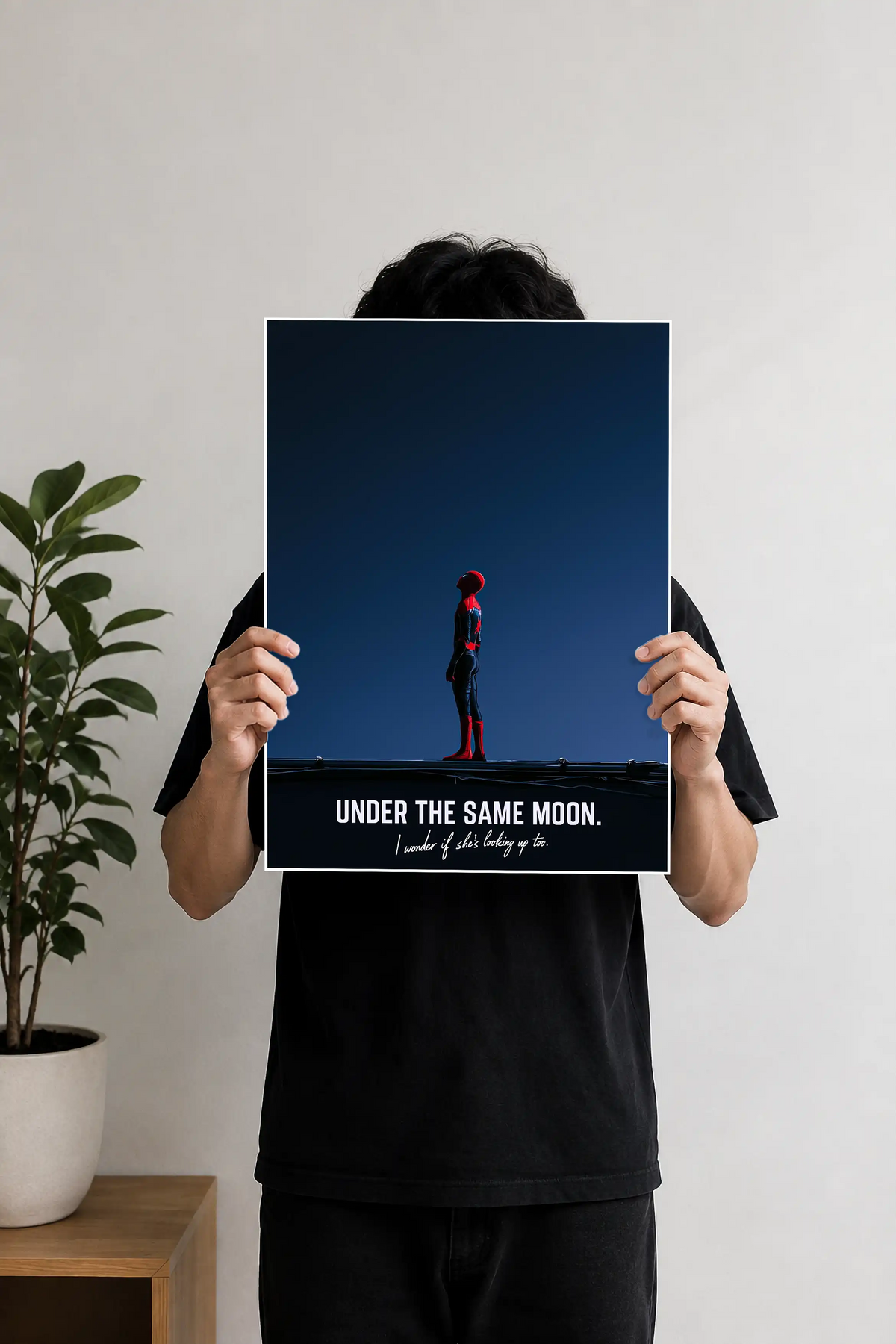 Image 2 (Desk Mockup View): Spider-Man "Under The Same Moon" wall art poster hanging above a wooden desk and black desk lamp.